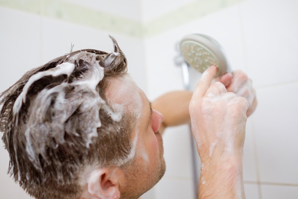 Man in shower with no hot water