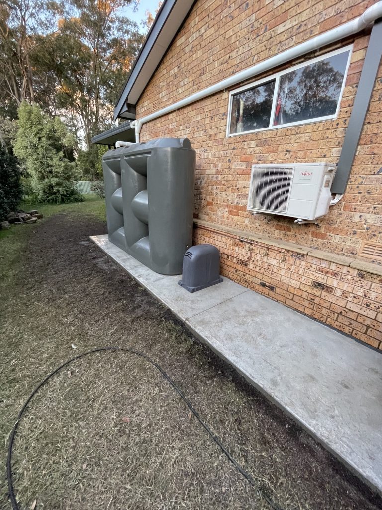 rainwater tank installed on the side of a house in Australia