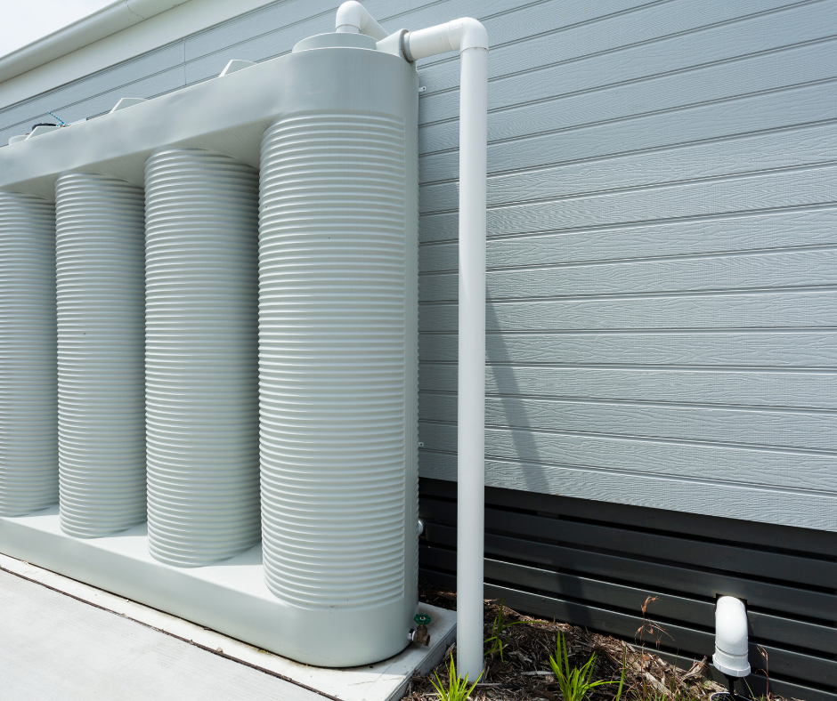 Rainwater tank installation on the side of a house
