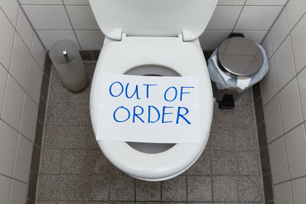 toilet bowl with Out of order sign on it